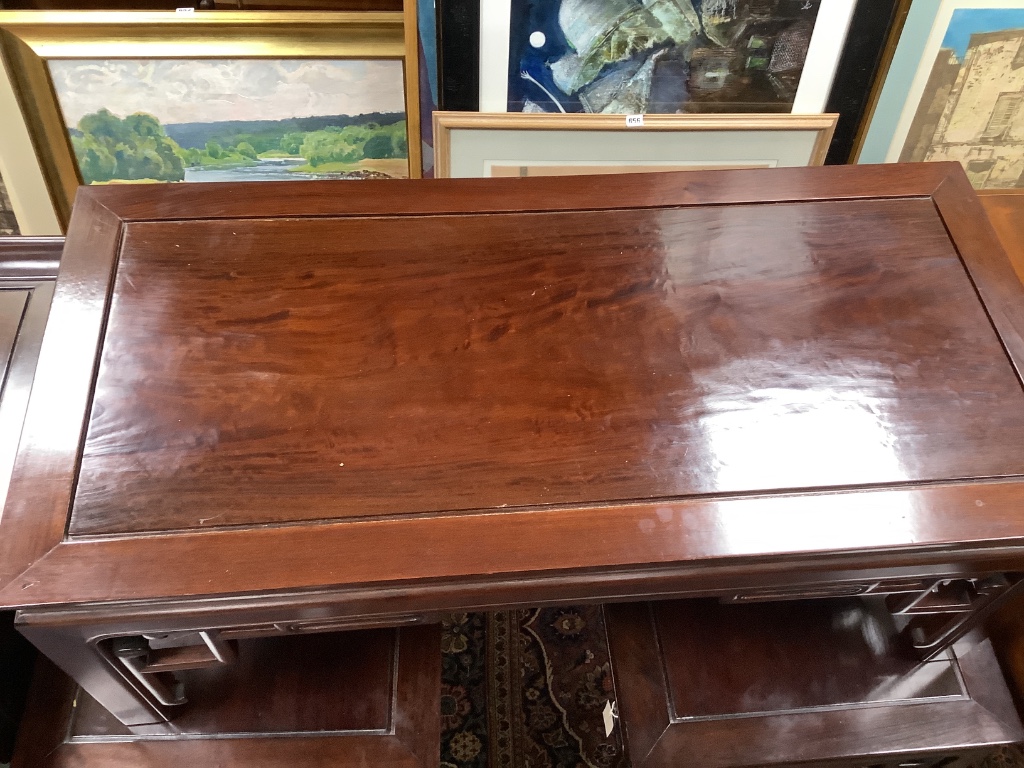 A 20th century Chinese rectangular hardwood low coffee table and a pair of similar lamp tables, largest width 106cm depth 51cm height 40cm